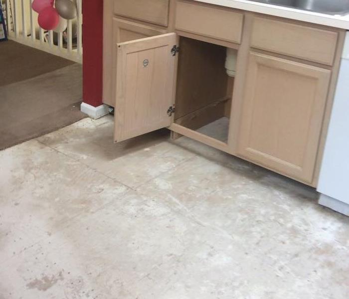 photo of bare cabinet and flooring