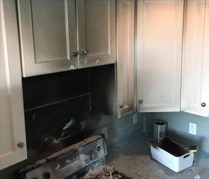 photo of damaged stove and soot in kitchen